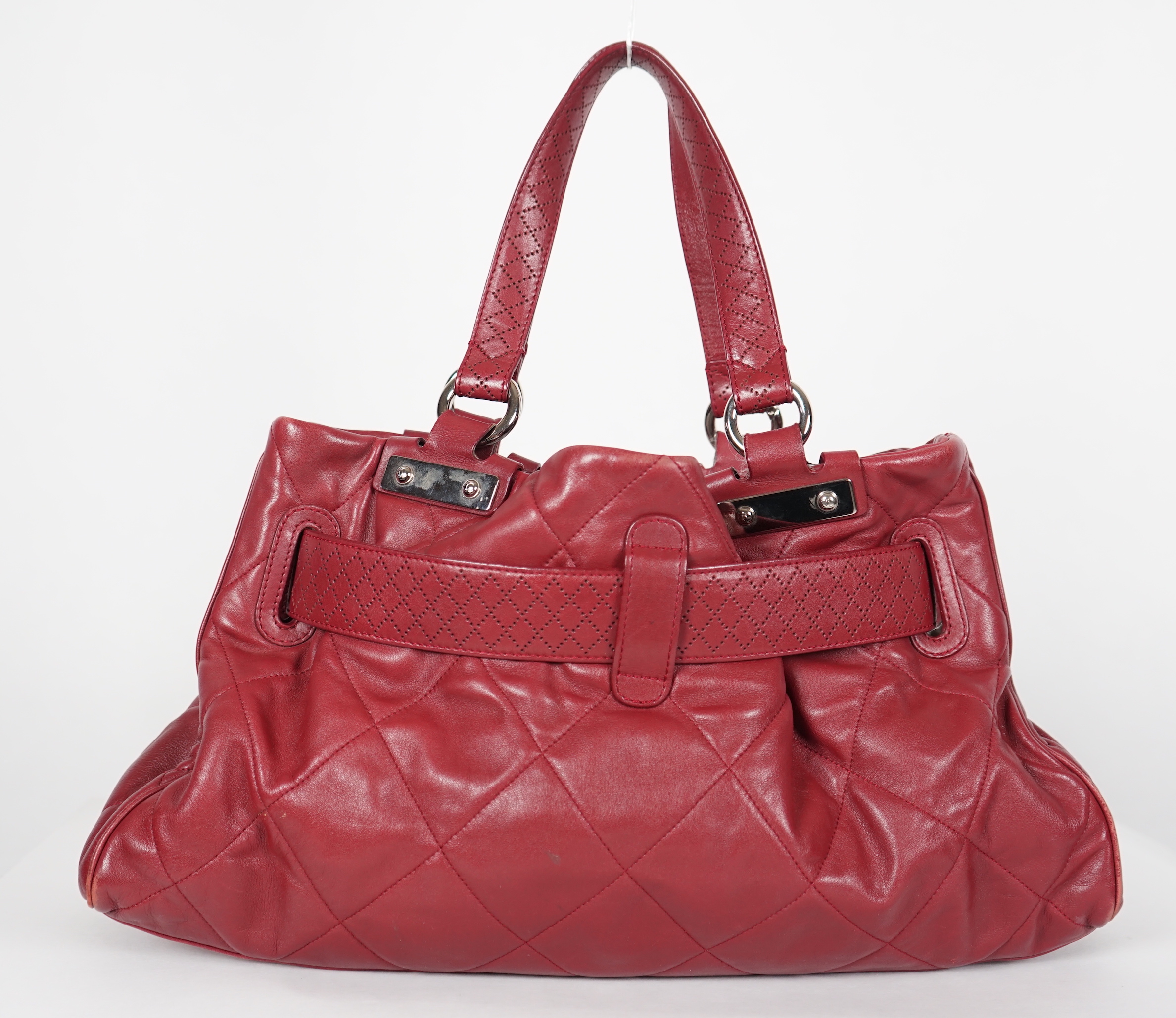 A Chanel burgundy leather buckled handle bag, with dust bag, height: 24.5cm, height overall 44cm, width 45cm, depth 16.5cm, Please note this lot attracts an additional import tax of 20% on the hammer price